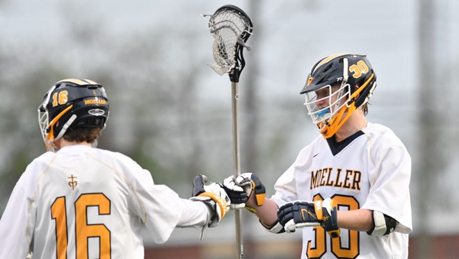 Moeller's Joey Koehne and Braedon Titus celebrate a first half goal against Mariemont Friday, May 4th at Roettger Field