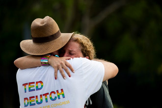 U.S. Reps. Debbie Wasserman Schultz and Ted Deutch hug after a truck drove into a crowd of people during a Pride parade in Wilton Manors near Fort Lauderdale on Saturday.