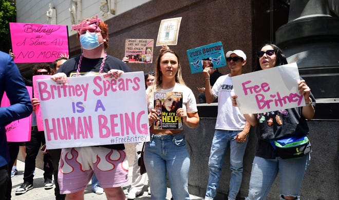 Fans and supporters hold "Free Britney" signs as they gather outside the County Courthouse in Los Angeles, California on June 23, 2021, during a scheduled hearing in Britney Spears' conservatorship case.