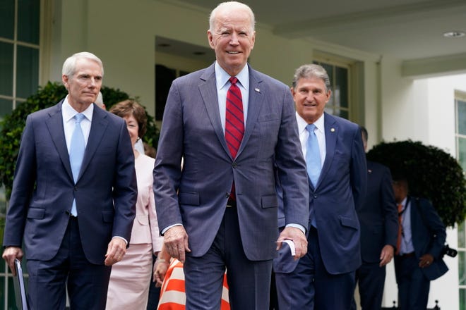President Joe Biden, with from left, Sen. Rob Portman, R-Ohio, Sen. Susan Collins, R-Maine, and Sen. Joe Manchin, D-W.Va., and a bipartisan group of senators, walks out to speak to the media, Thursday June 24, 2021, outside the White House in Washington. Biden invited members of the group of 21 Republican and Democratic senators to discuss the infrastructure plan.