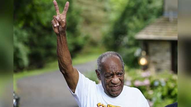 Bill&#x20;Cosby&#x20;gestures&#x20;outside&#x20;his&#x20;home&#x20;in&#x20;Elkins&#x20;Park,&#x20;Pa.,&#x20;Wednesday,&#x20;June&#x20;30,&#x20;2021,&#x20;after&#x20;being&#x20;released&#x20;from&#x20;prison.&#x20;Pennsylvania&#x27;s&#x20;highest&#x20;court&#x20;has&#x20;overturned&#x20;comedian&#x20;Cosby&#x27;s&#x20;sex&#x20;assault&#x20;conviction.