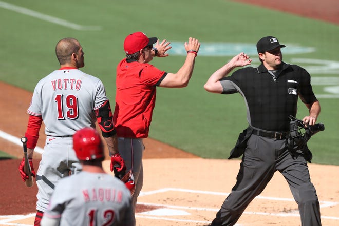 Joey Votto (19) and manager David Bell, center, of the Cincinnati Reds are ejected in the first inning following a heated argument with home plate umpire Ryan Additon, right, Saturday, June 19, 2021, in San Diego. (AP Photo/Derrick Tuskan)