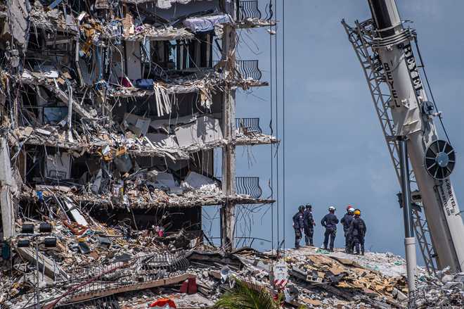 Members&#x20;of&#x20;the&#x20;South&#x20;Florida&#x20;Urban&#x20;Search&#x20;and&#x20;Rescue&#x20;team&#x20;look&#x20;for&#x20;possible&#x20;survivors&#x20;in&#x20;the&#x20;partially&#x20;collapsed&#x20;12-story&#x20;Champlain&#x20;Towers&#x20;South&#x20;condo&#x20;building&#x20;on&#x20;June&#x20;27,&#x20;2021&#x20;in&#x20;Surfside,&#x20;Florida.