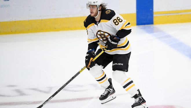 Boston Bruins right wing David Pastrnak (88) skates with the puck during the second period of an NHL hockey game against the Washington Capitals, Saturday, Jan. 30, 2021, in Washington. (AP Photo/Nick Wass)