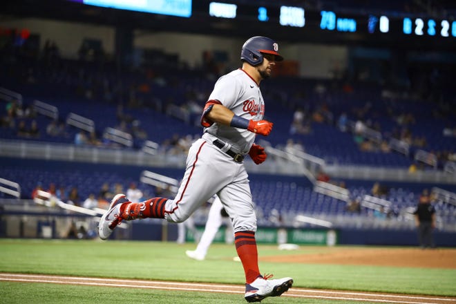 Washington Nationals left fielder Kyle Schwarber (12) rounds first base after hitting a solo home run during the first inning of a baseball game on Thursday, June 24, 2021, in Miami. (AP Photo/Mary Holt)