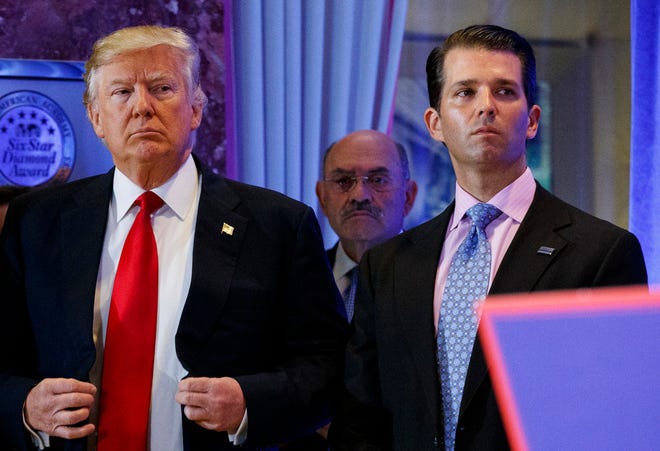 In this Jan. 11, 2017, shows President-elect Donald Trump, left, his chief financial officer Allen Weisselberg, center, and his son Donald Trump Jr., right, attend a news conference in the lobby of Trump Tower in New York. Manhattan prosecutors have informed Donald Trump’s company that it could soon face criminal charges stemming from a long-running investigation into the former president’s business dealings. The New York Times reported that charges could be filed against the Trump Organization as early as next week related to fringe benefits the company gave to top executives, such as use of apartments.