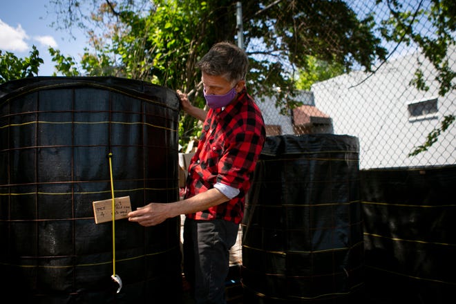 Gary Dangel works with his bioreactors that help with composting materials, inside of the Taft Garden, one of eight gardens in Walnut Hills. He is the food access coordinator for the Walnut Hills Redevelopment Foundation.