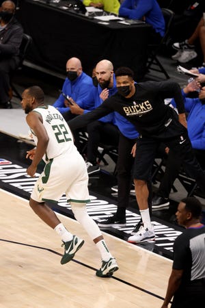 Giannis Antetokounmpo congratulates Khris Middleton after a basket during the third quarter of the Bucks' Game 6 win over the Hawks.