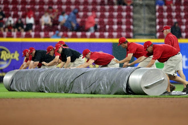 The Cincinnati Reds grounds crew rolls out the tarp in the sixth inning during a baseball game between the San Diego Padres and the Cincinnati Reds, Wednesday, June 30, 2021, at Great American Ball Park in Cincinnati. The game was called in the sixth inning and with the San Diego Padres won, 7-5.