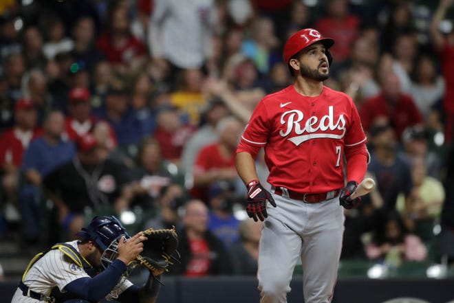 Cincinnati Reds' Eugenio Suarez (7) watches his solo home run during the ninth inning of a baseball game against the Milwaukee Brewers, Saturday, July 10, 2021, in Milwaukee. (AP Photo/Aaron Gash)