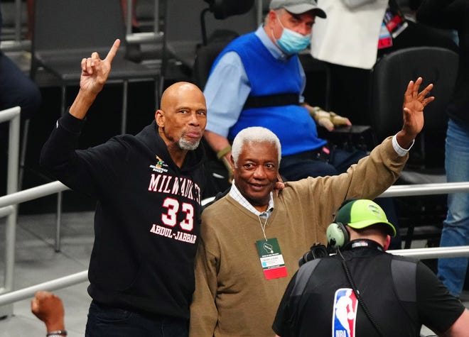 Jul 14, 2021; Milwaukee, Wisconsin, USA; NBA former player Kareem Abdul-Jabbar and former player Oscar Robertson wave to the crowd during the second quarter in game four of the 2021 NBA Finals between the Milwaukee Bucks and the Phoenix Suns at Fiserv Forum.