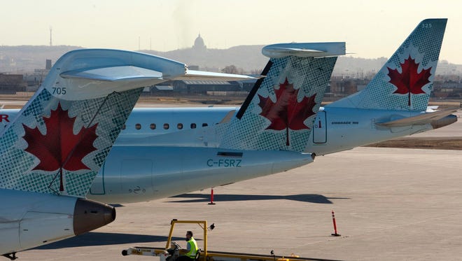 Canada Prime Minister Justin Trudeau indicated Thursday that its borders could be reopening to U.S. travelers this summer. This file photo from March 23, 2012, shows Air Canada planes at the Pierre Trudeau Airport in Montreal.
