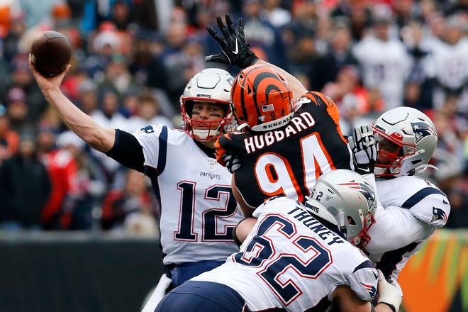 Cincinnati Bengals defensive end Sam Hubbard (94) rushes New England Patriots quarterback Tom Brady (12) as he throws in the second quarter of the NFL Week 15 game between the Cincinnati Bengals and the New England Patriots at Paul Brown Stadium in downtown Cincinnati on Sunday, Dec. 15, 2019. The Patriots led 13-10 at the half.