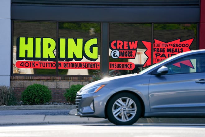 A "now hiring" marquee on display on a window of a Wendy's fast-food restaurant along Beechmont Avenue, Thursday, May 6, 2021, in the Mount Washington neighborhood of Cincinnati.