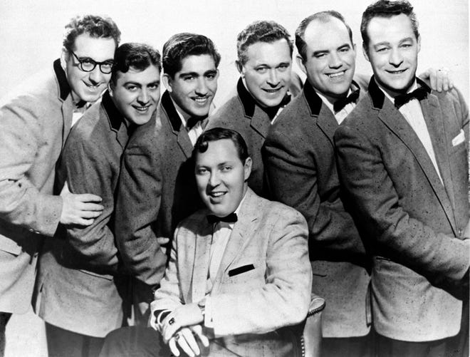 Pioneer rock 'n' roller Bill Haley, seated, and his Comets rocked around and around the clock with their hit, which in 1955 was the first rock record to hit the top of the Billboard Pop charts, where it stayed for eight weeks.