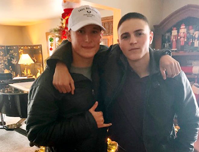 This Dec. 2019, photo provided by Regi Stone shows Eli Stone, left, and Rylee McCollum, at Christmas in Stone's house in Jackson, Wyo. Rylee McCollum, of Bondurant, Wyo., was one of the U.S. Marines killed in the suicide bombing at the Kabul airport, in Afghanistan, according to his sister, Roice McCollum.