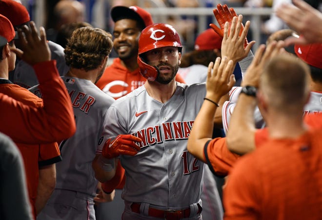 Cincinnati Reds center fielder Tyler Naquin (12) celebrates a solo home run with teammates against the Miami Marlins during the first inning at loanDepot Park on Aug. 27.
