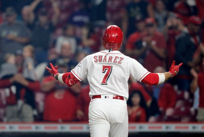 Sep 20, 2021; Cincinnati, Ohio, USA; Cincinnati Reds third baseman Eugenio Suarez (7) reacts after hitting a solo home run against the Pittsburgh Pirates during the fifth inning at Great American Ball Park.