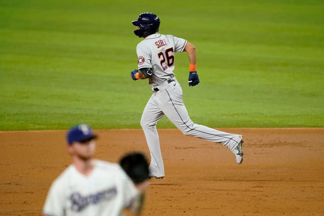 Houston Astros' Jose Siri rounds the bases after hitting a two-run home run off of Texas Rangers starting pitcher A.J. Alexy, front, in the third inning of a baseball game in Arlington, Texas, Monday, Sept. 13, 2021. The shot scored Jake Meyers. (AP Photo/Tony Gutierrez)