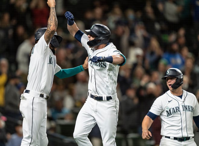 Mitch Haniger celebrates a home run against Oakland with J.P. Crawford.