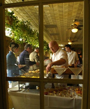 Adam Gilreath fills dishes for Easter brunch at the Grand Finale.
