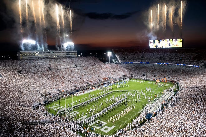 The Penn State football team runs onto the field to take on Auburn in a White Out game at Beaver Stadium.