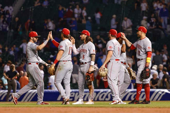 Cincinnati Reds players celebrate their 4-3 win against the Chicago Cubs at Wrigley Field on Sept. 7.