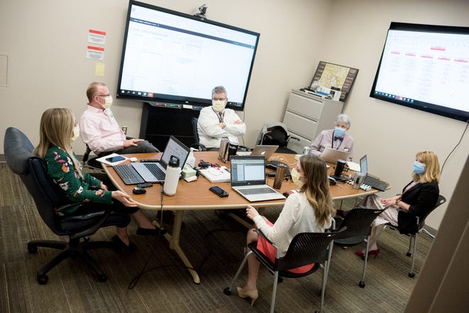 Officials with the COVID-19 incident command at the University of Cincinnati Medical Center meet to plan the hospital's response to the coronavirus pandemic, including use of the online tool Surgenet to monitor bed capacity, supplies and other resources.