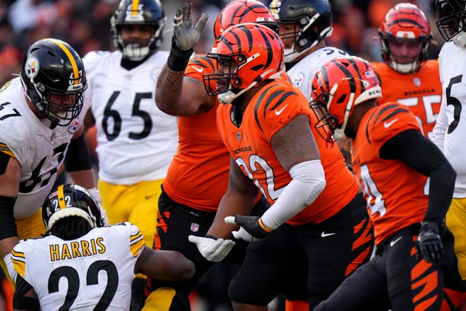 Cincinnati Bengals defensive end B.J. Hill (92) celebrates a tackle of Pittsburgh Steelers running back Najee Harris (22) in the second quarter during a Week 12 NFL football game, Sunday, Nov. 28, 2021, at Paul Brown Stadium in Cincinnati. The Cincinnati Bengals won, 41-10.
