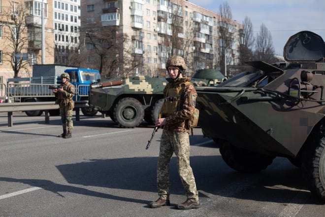 Ukrainian servicemen stand on patrol at a security checkpoint on Feb. 25, 2022 in Kyiv, Ukraine.