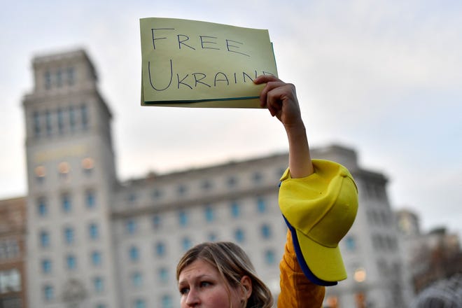 A demonstrator holds a sign reading "Free Ukraine" during a protest against Russia's military operation in Ukraine, in Barcelona on February 24, 2022. - Russia's President Vladimir Putin has launched a military operation in Ukraine on February 24, 2022 after weeks of intense diplomacy and the imposition of Western sanctions on Russia that failed to deter him.